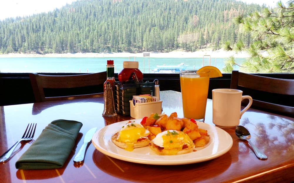Eggs Benedict meal with vista of Bass Lake in the background